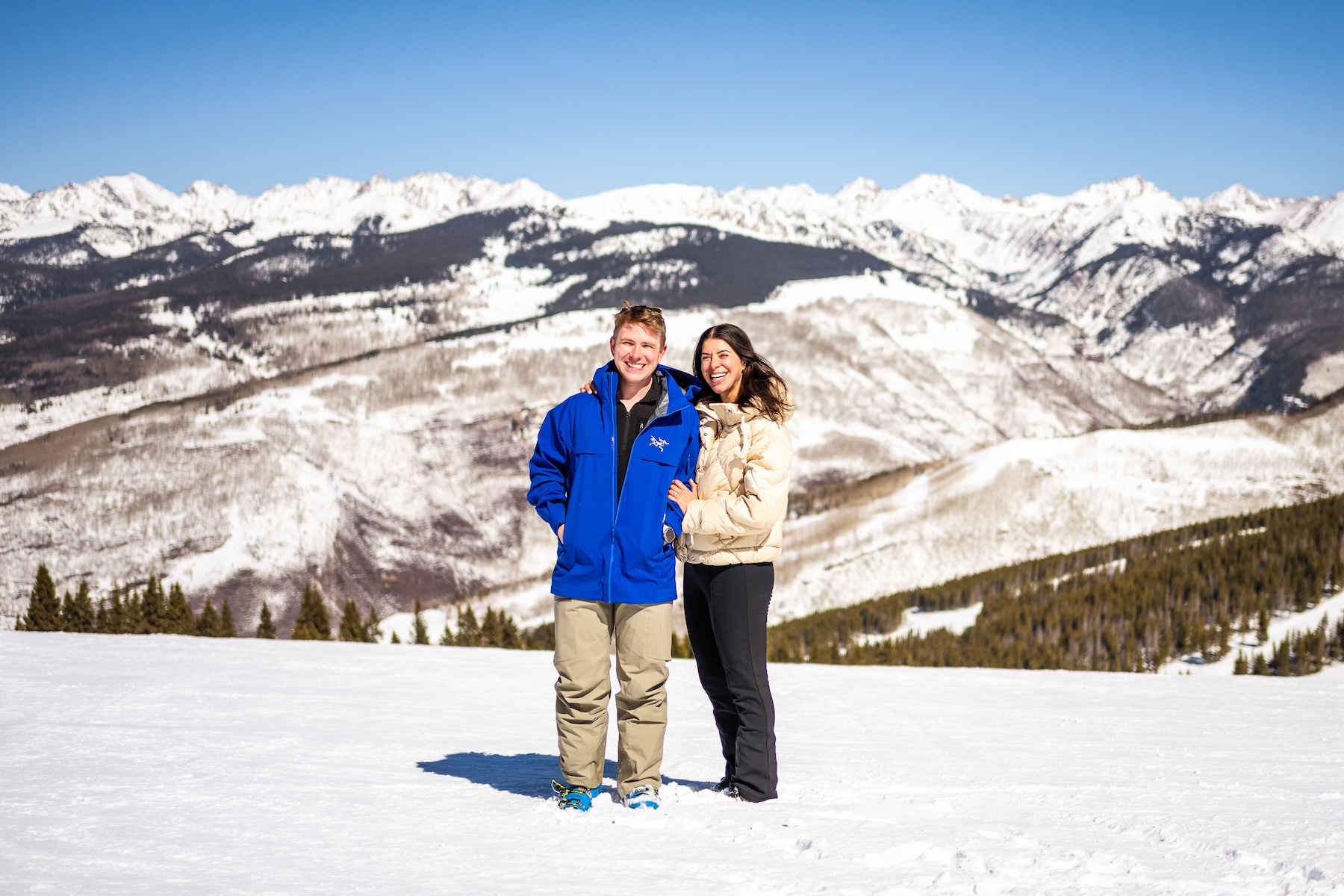 Derek and Shira standing together in snow-covered mountains